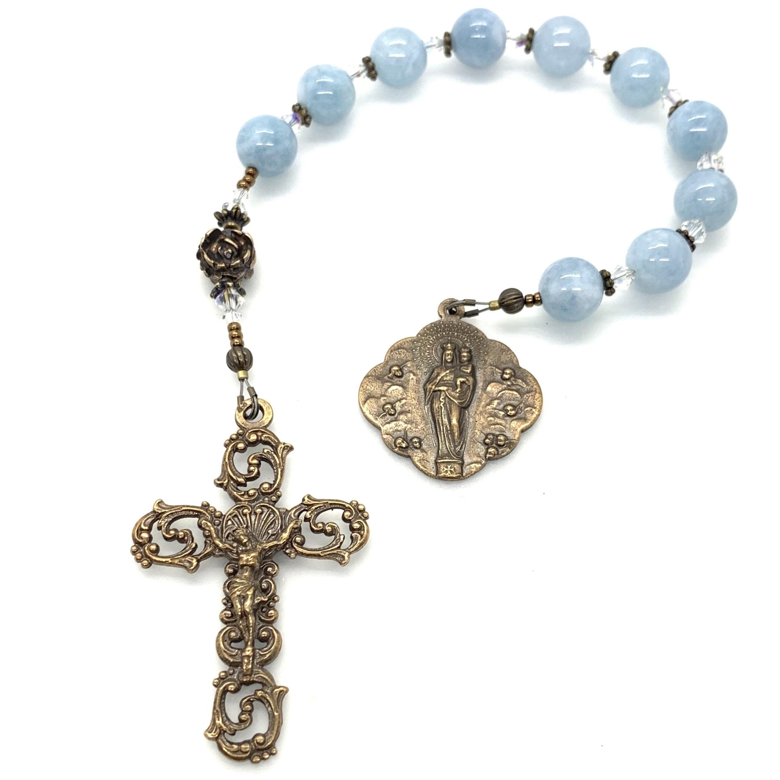 Aquamarine hail Mary rosary beads with bronze medal and crucifix on decade rosary tenner