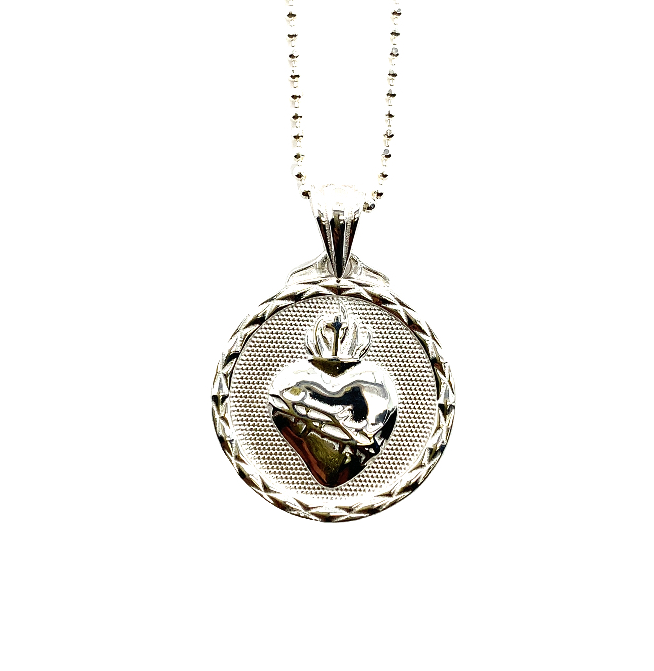 Sterling silver necklace pendant featuring the sacred heart of Jesus.