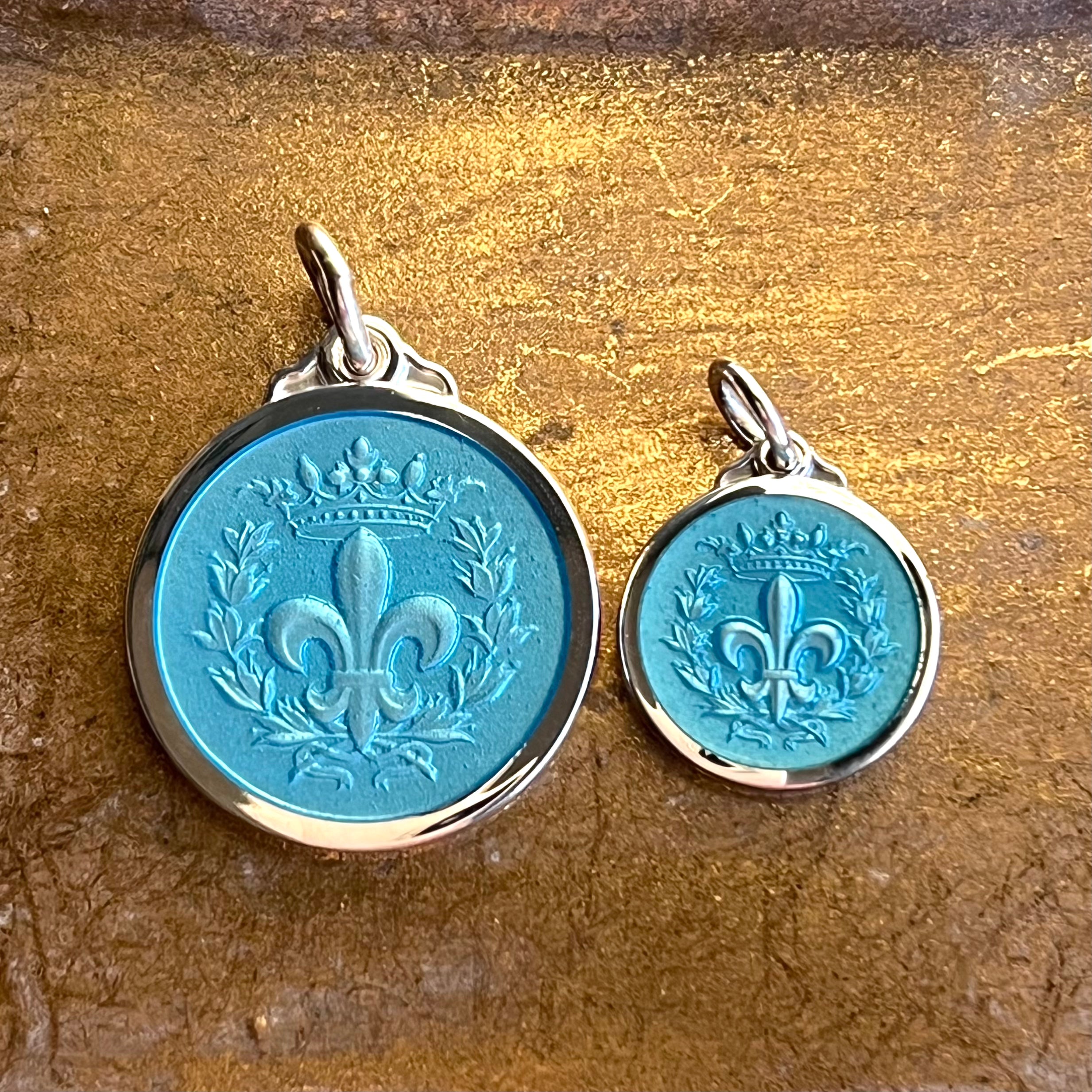 Two sizes of sterling silver and enamel aqua colored fleur-de-lis necklace pendants