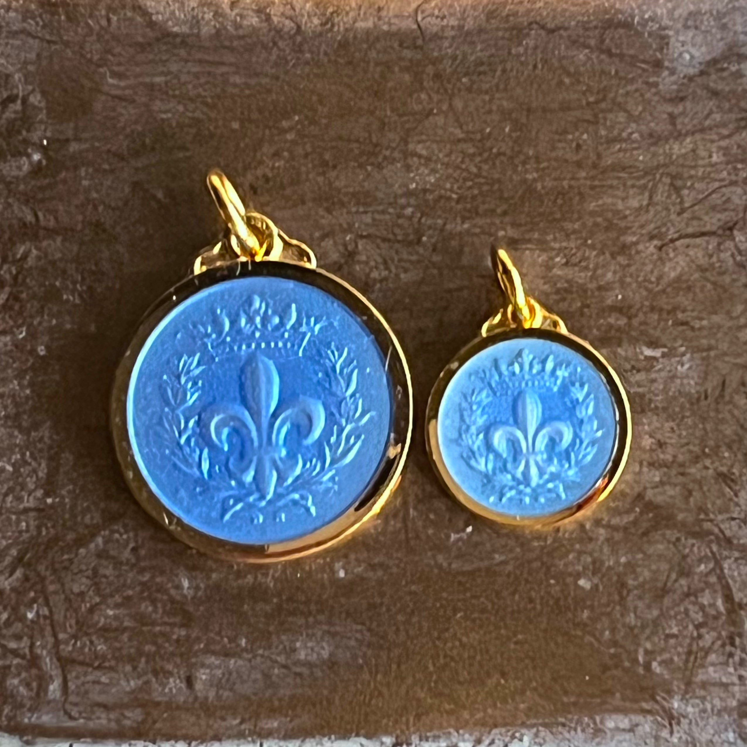two french blue enamel necklace pendants featuring a fleur de lis
