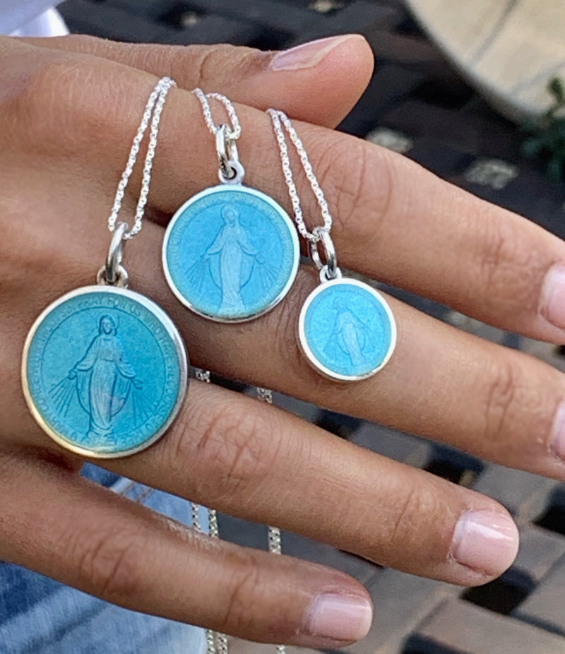 Three Religious medals that are light blue enamel with silver chain