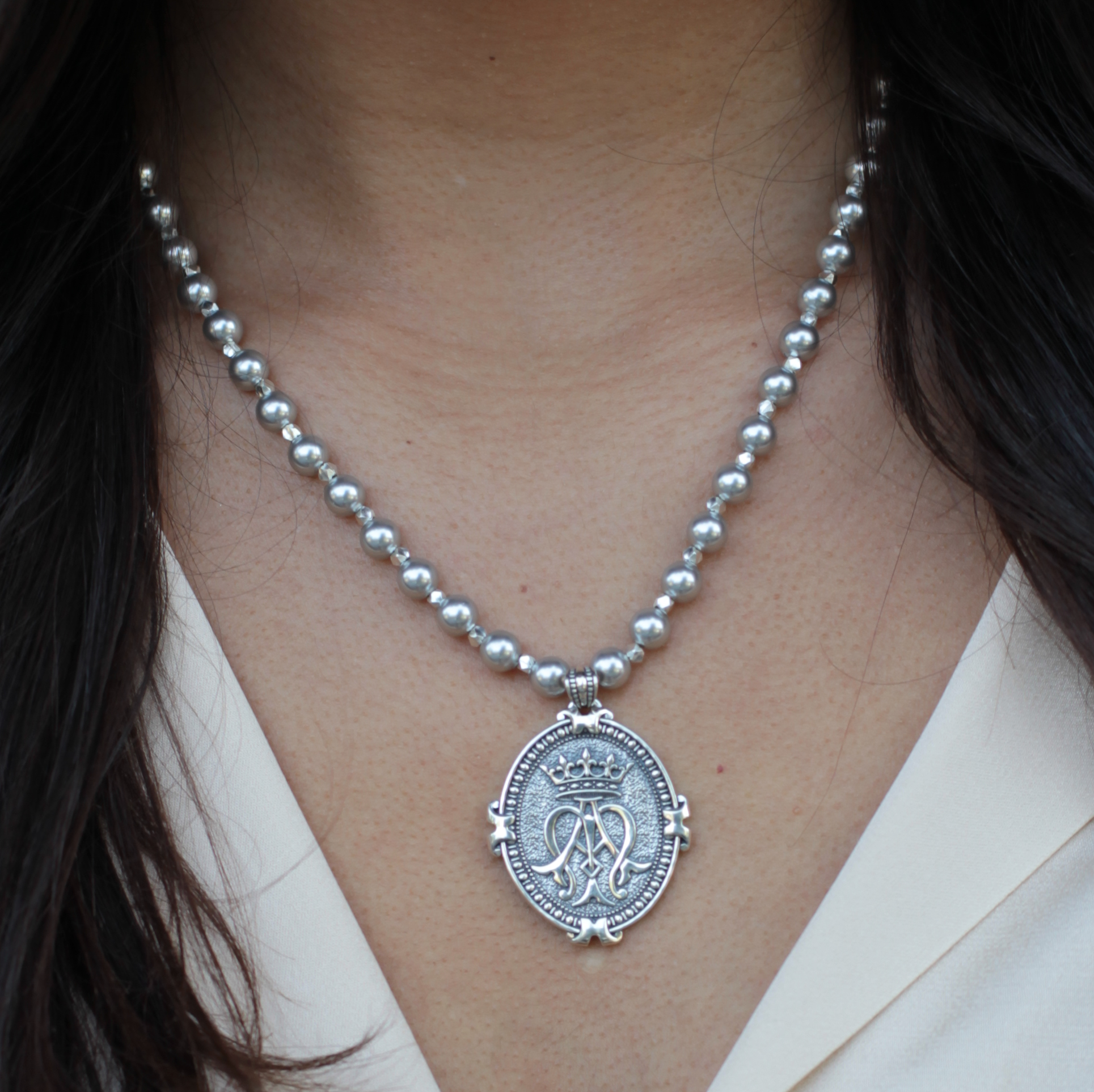 Necklace pendant of sterling silver with silver pearls featuring auspice maria logo