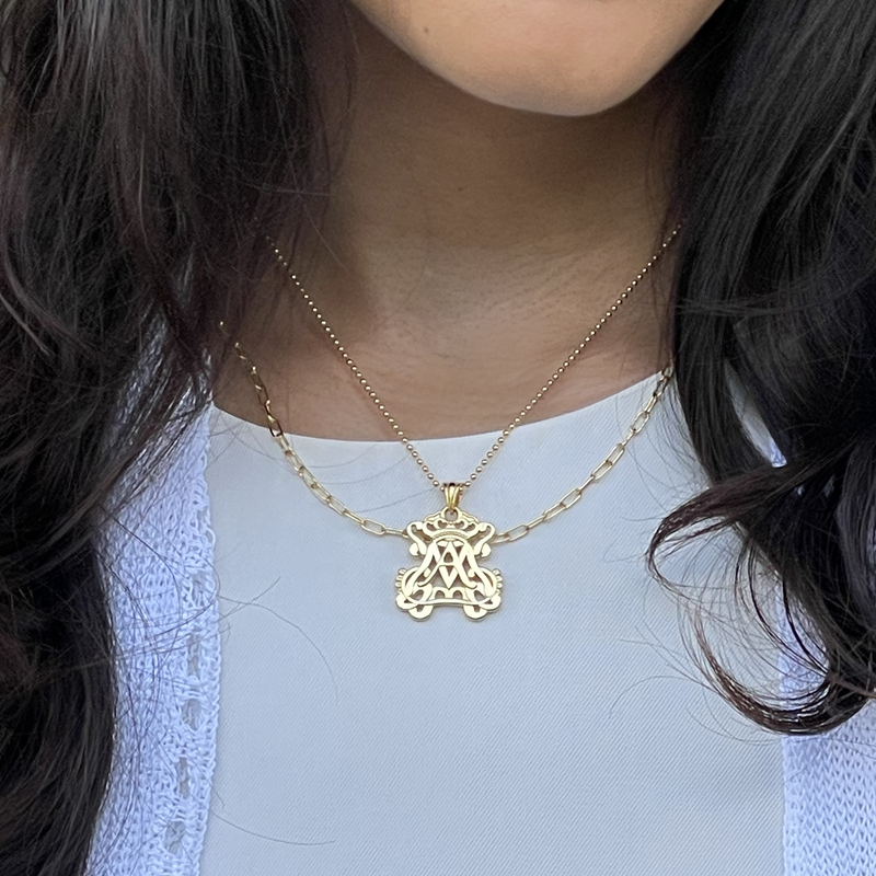 Gold auspice maria openwork necklace pendant featuring an intertwined A and M