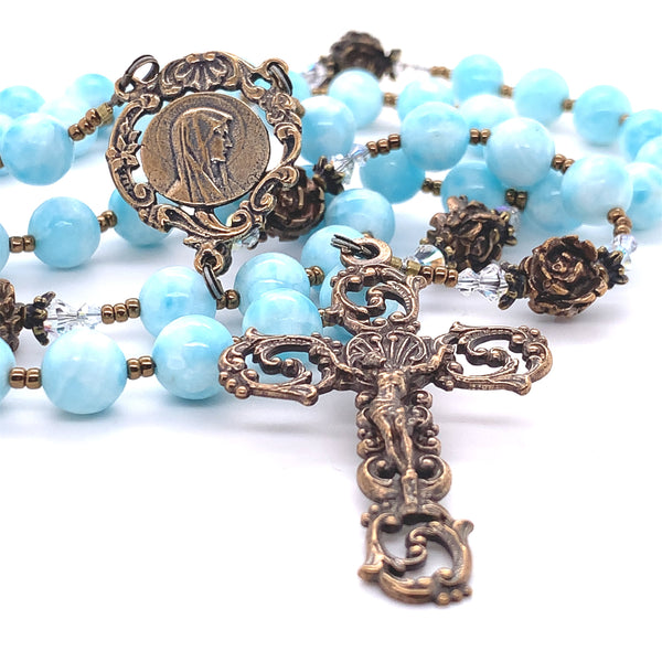 bronze crucifix with bronze rose beads and blue hail mary beads on making up traditional rosary