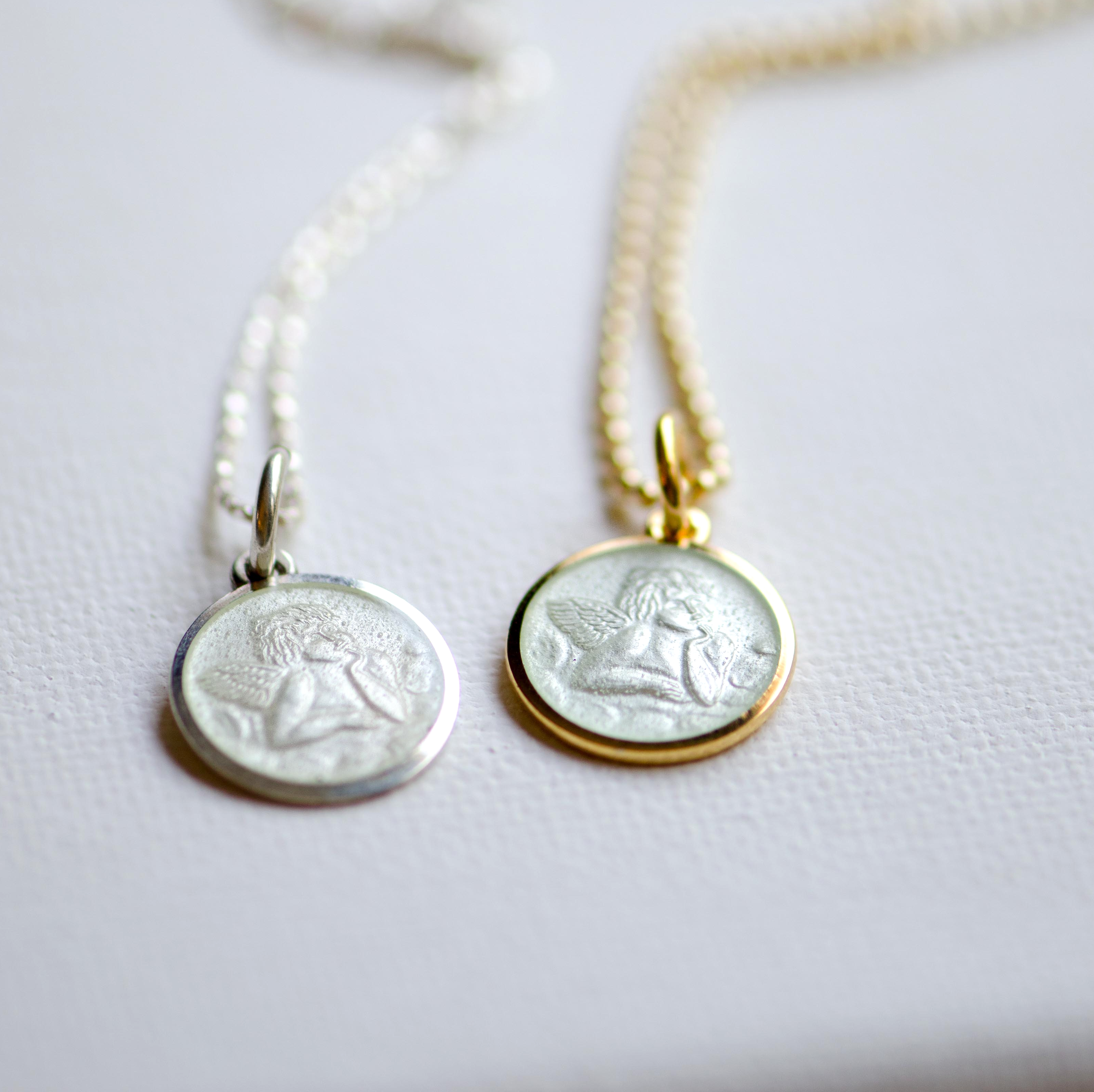 Cherub pendant in sterling silver and gold overlay featuring a white cream enamel overlay