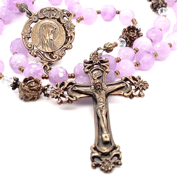 Traditional rosary with our Lady profile center and scrolls crucifix both in bronze and cape amethyst pink faceted beads and Swarovski crystals
