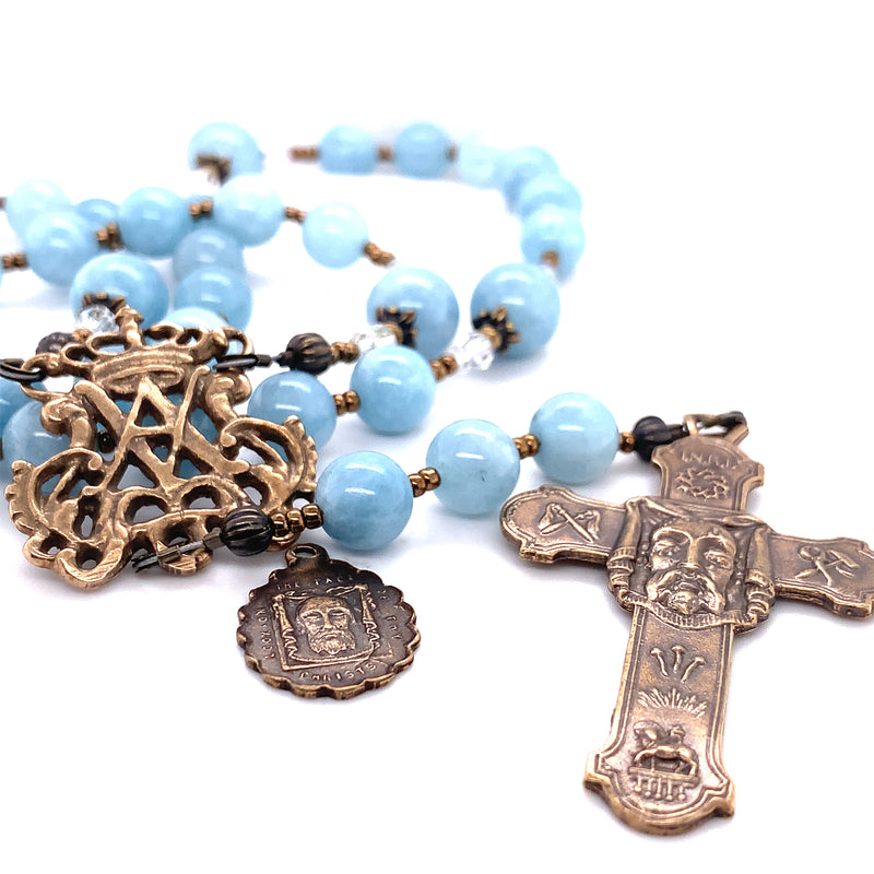 Chaplet with blue aquamarine beads showing the holy face of Jesus and an Auspice Maria center in bronze