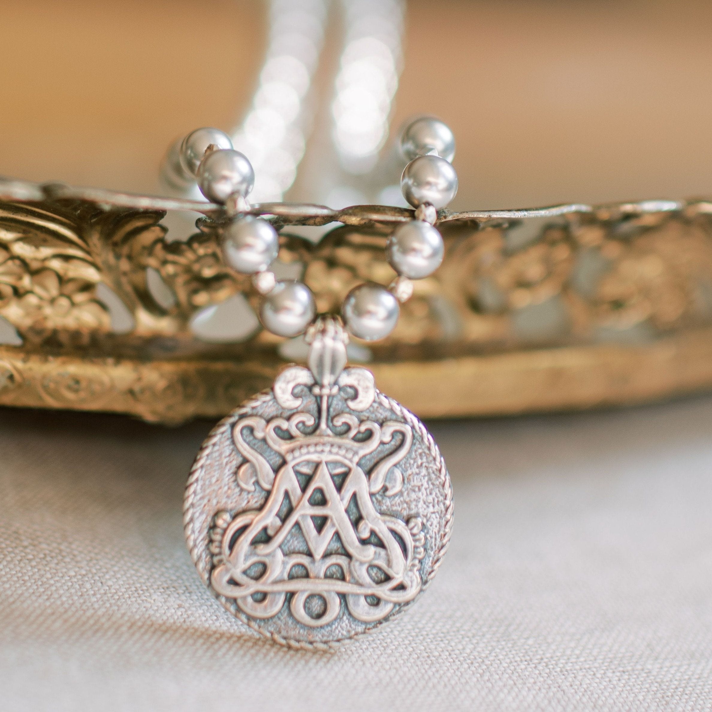 Pendant Necklace featuring Auspice Maria Signature design with miraculous medal on reverse, on a necklace of Swarovski grey imitation pearls