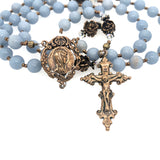 rosary with blue angel stone beads and a bronze crucifix and a bronze center showing a profile of our lady.  Also shown are bronze rose our father beads.