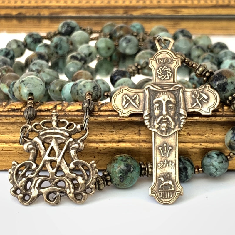 Auspice Maria center on left and Holy Face cross on the right. Ave Maria African Turquoise Rosary beads in background.