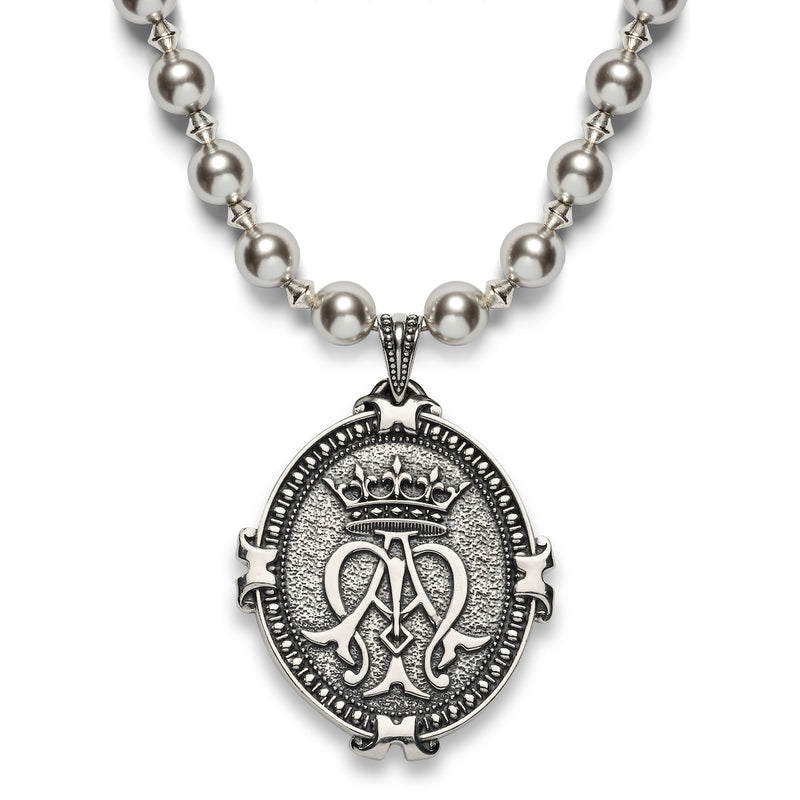 A sterling silver necklace of pearls and a pendant featuring the Auspice Maria or Ave Maria emblem