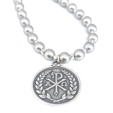 Sterling silver pendant with Chi Rho symbol and the Alpha and Omega.  The greek letters are bordered on this round pendant by a wheat crest 