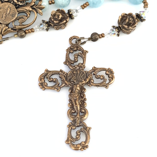 Bronze scroll crucifix with rose beads.