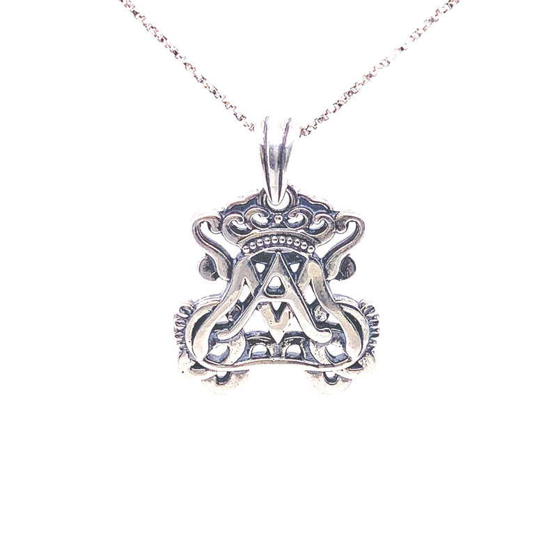 large silver pendant on silver chain featuring openwork auspice maria insignia