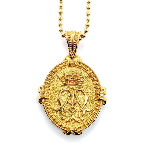 Gold pendant hanging on bead chain showing auspice maria emblem with crown over A and M.  Sometimes referred to as Ave Maria Necklace.