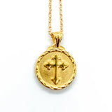 backside of a sacred heart necklace pendant featuring a cross.
